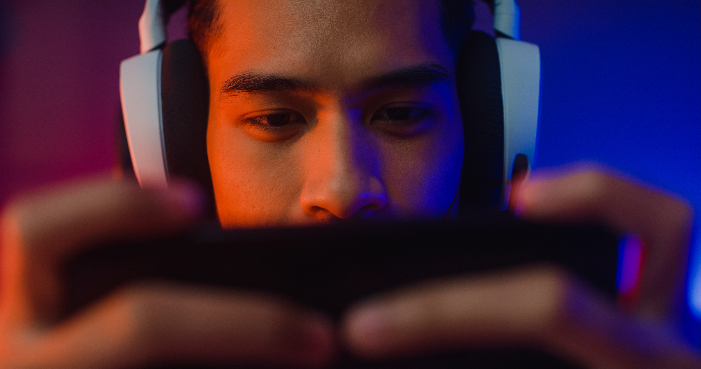 Gamer with headphones playing a mobile game