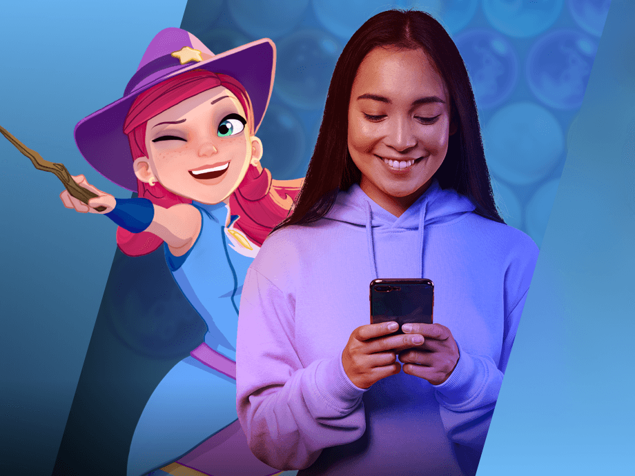 Stella, de <em>The Bubble Witch</em>, posando con una mujer joven que juega a juegos de móvil.