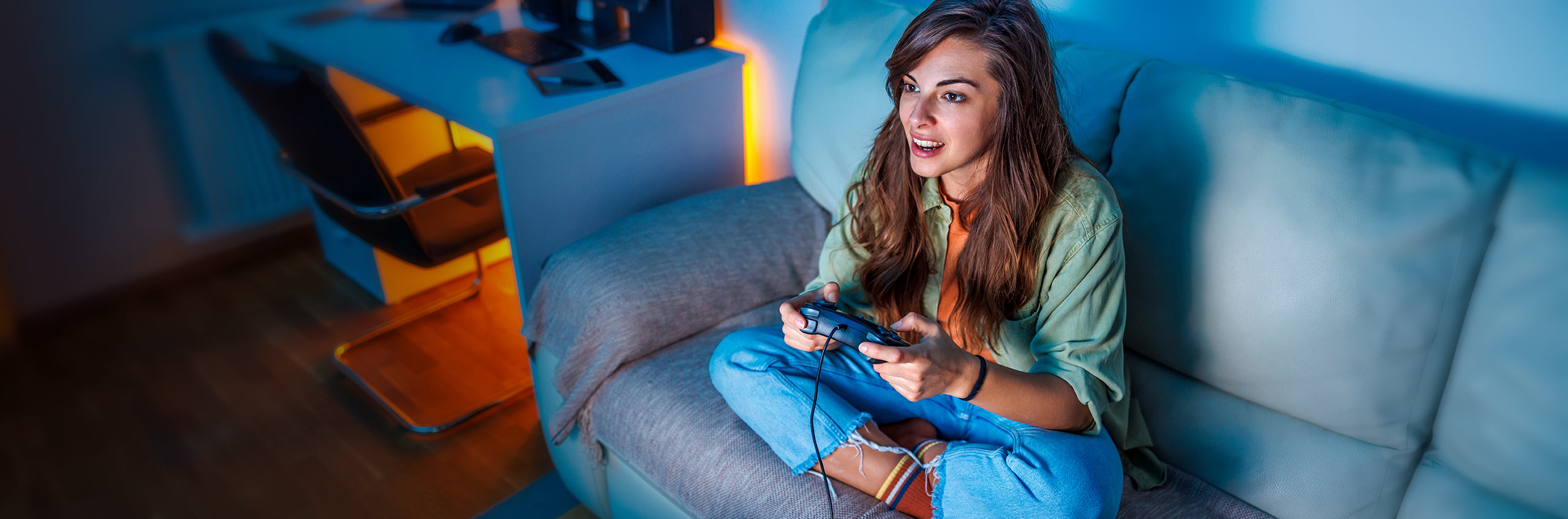 Woman gaming on her couch at home